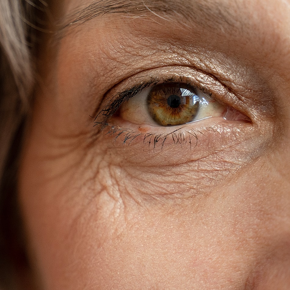 Woman with styled hair and natural makeup.