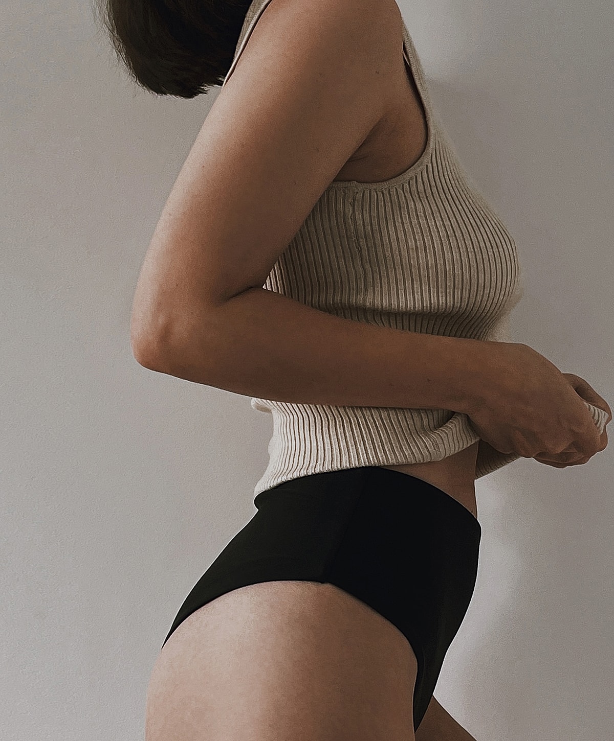 Woman with styled hair and natural makeup.