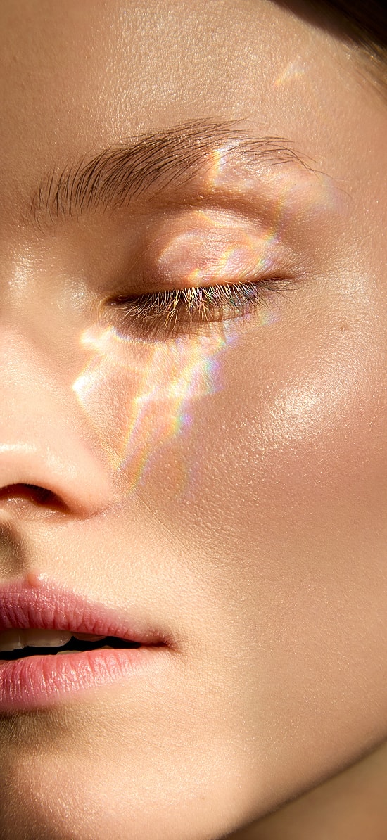 Woman with styled hair and natural makeup.
