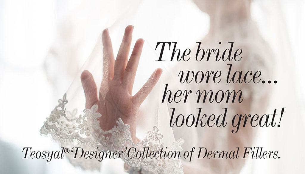 Bride's lace veil with a hand in focus.