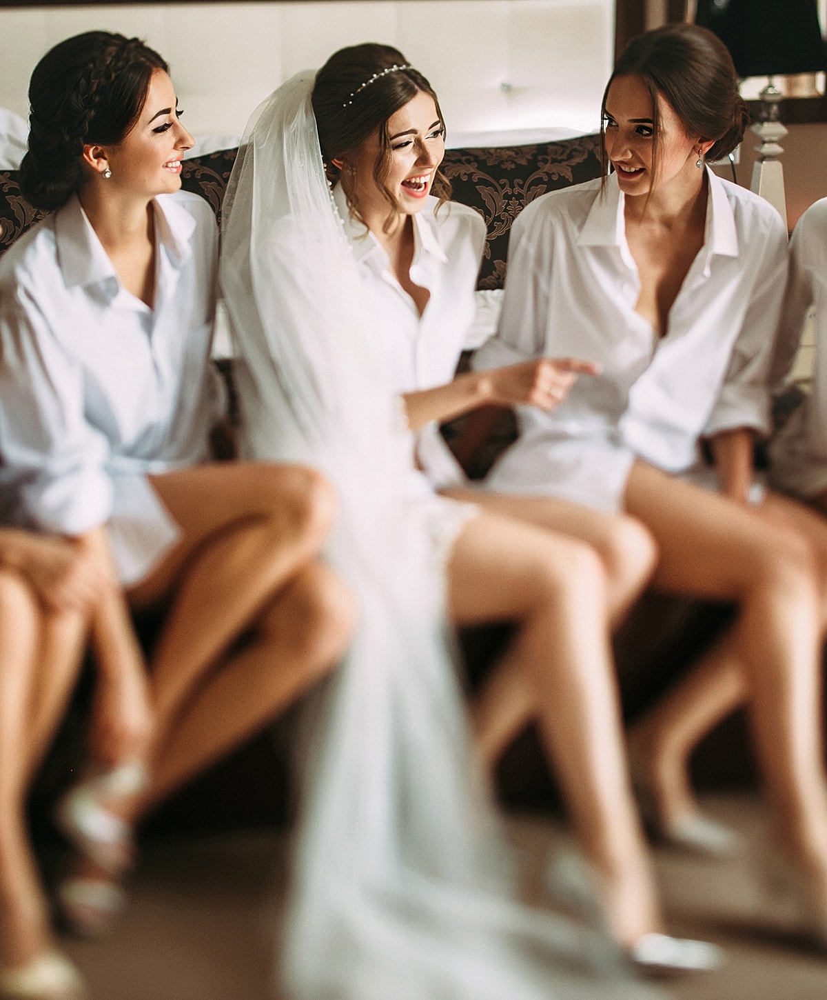 Woman posing in white activewear against neutral background.