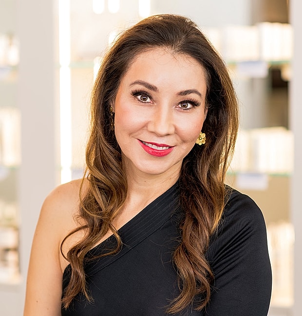 Smiling woman with long hair in black outfit