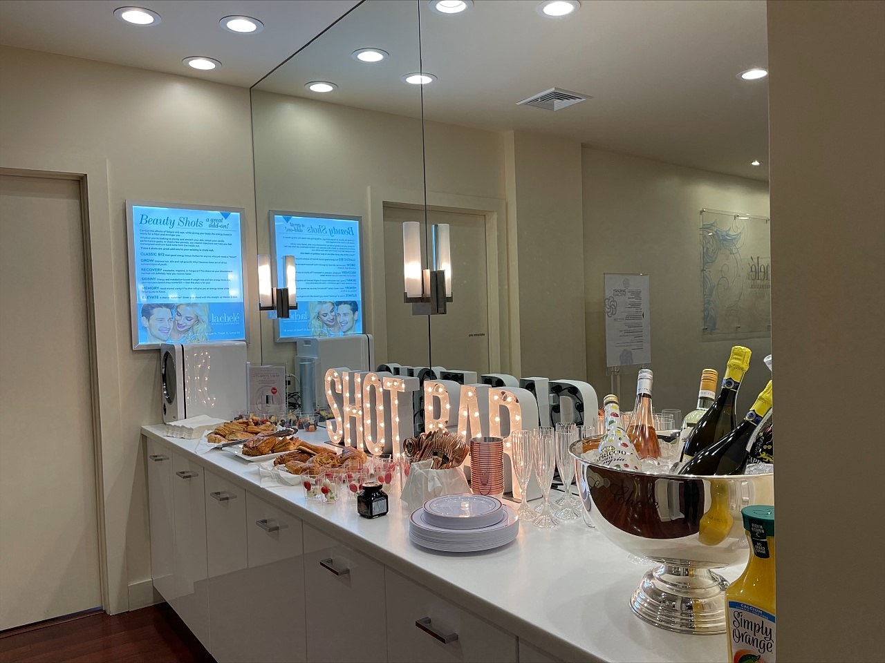 Buffet table with drinks and snacks displayed.