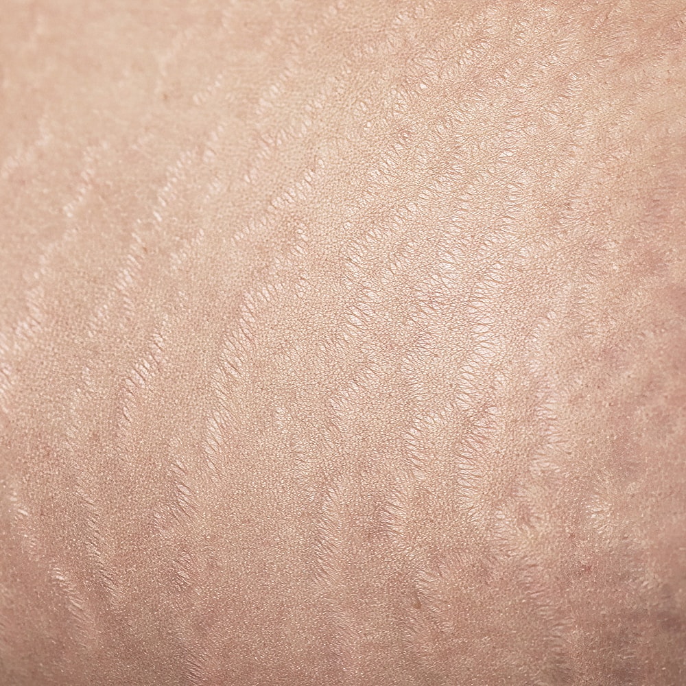 Woman with styled hair and natural makeup.