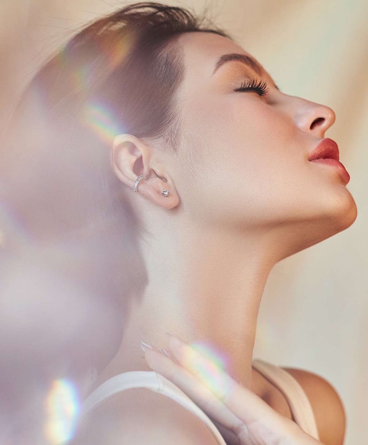 Profile view of a woman with elegant earrings.