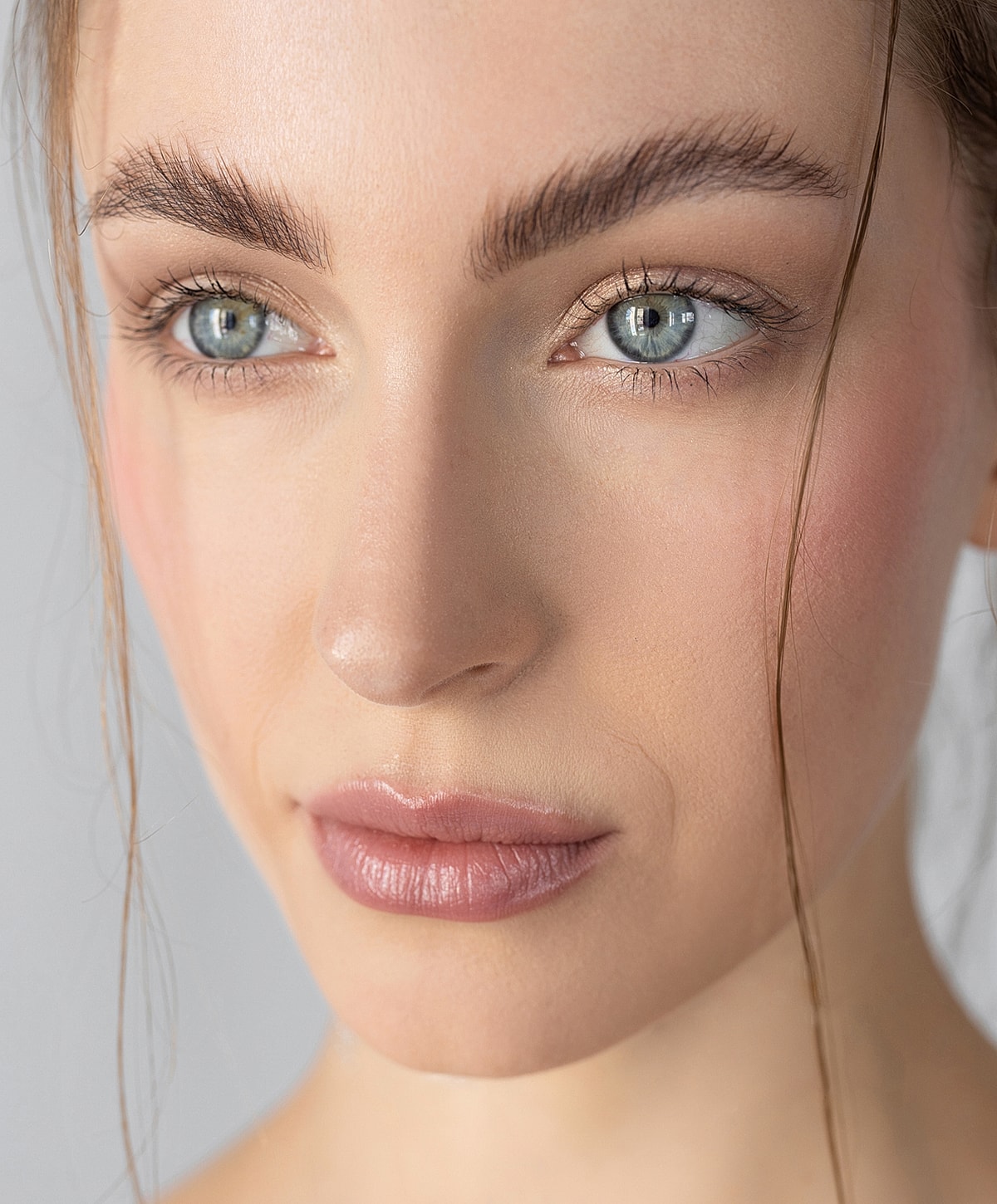 Close-up of a woman's face with natural makeup.