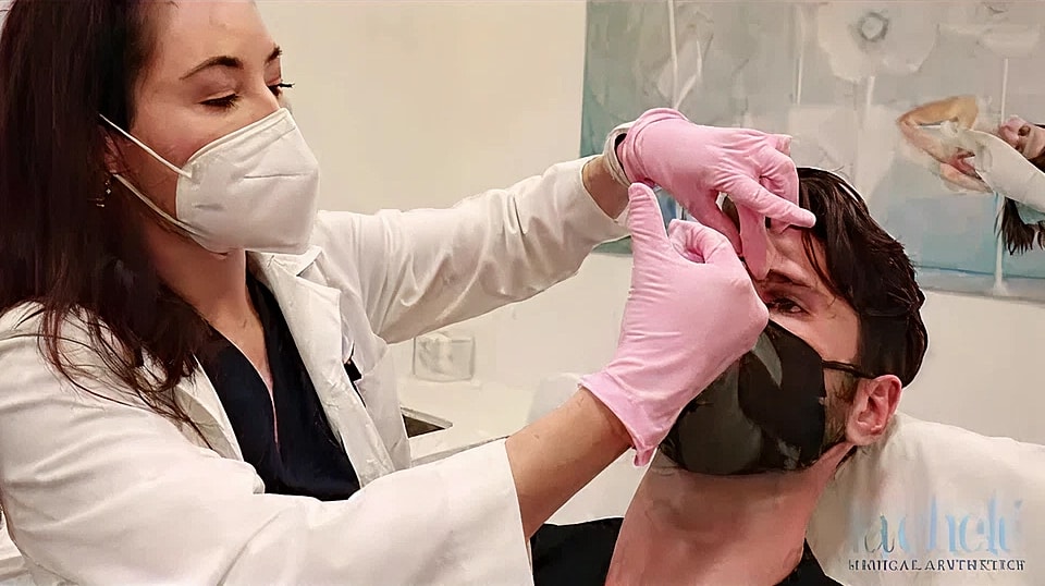 Medical professional performing treatment on patient.