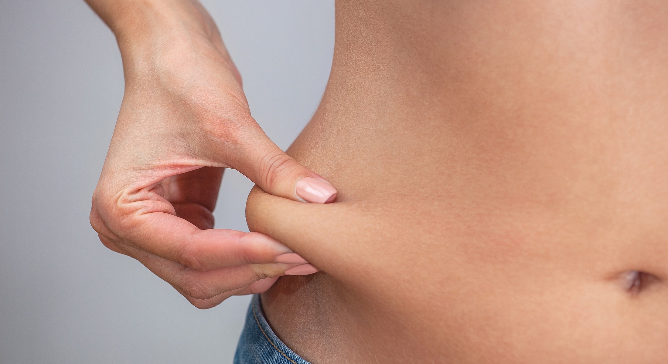 Person pinching skin on abdomen.