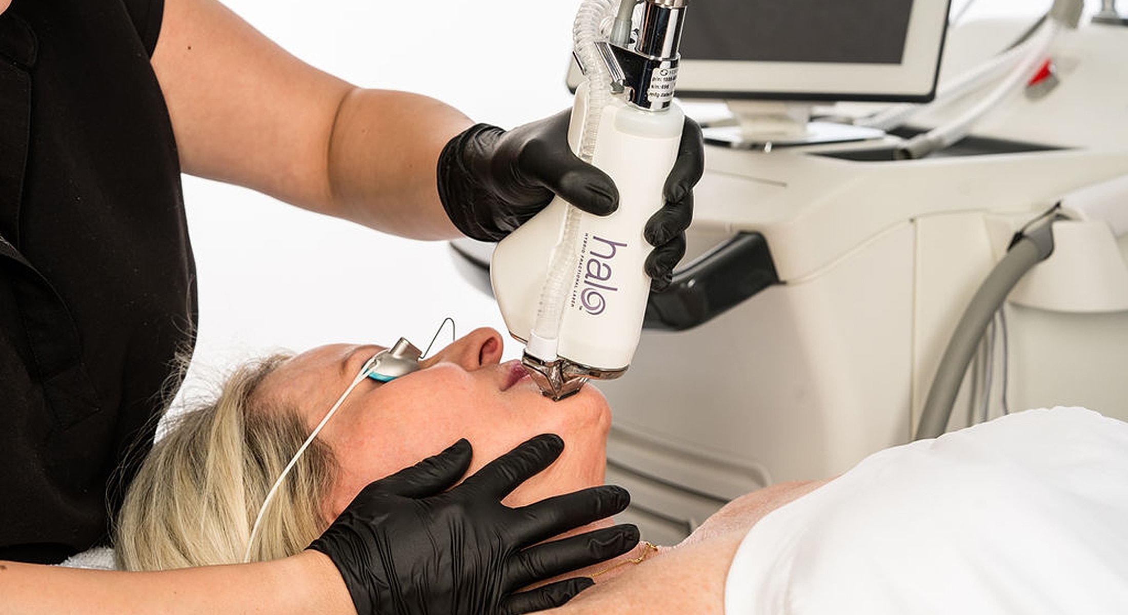 Laser facial treatment being performed on a client.