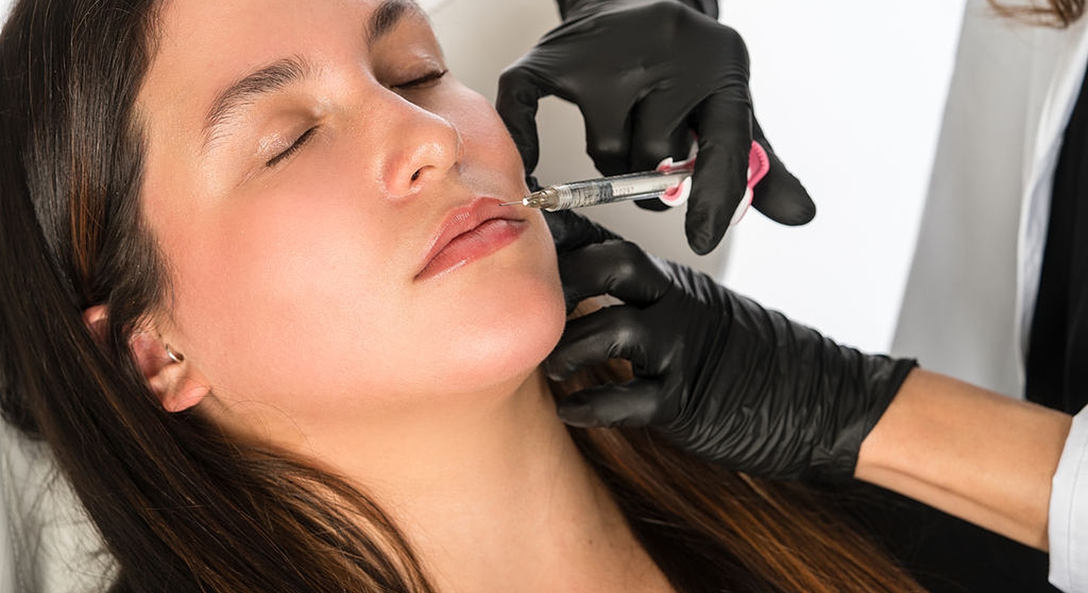 Lip injection procedure with medical professional administering treatment.