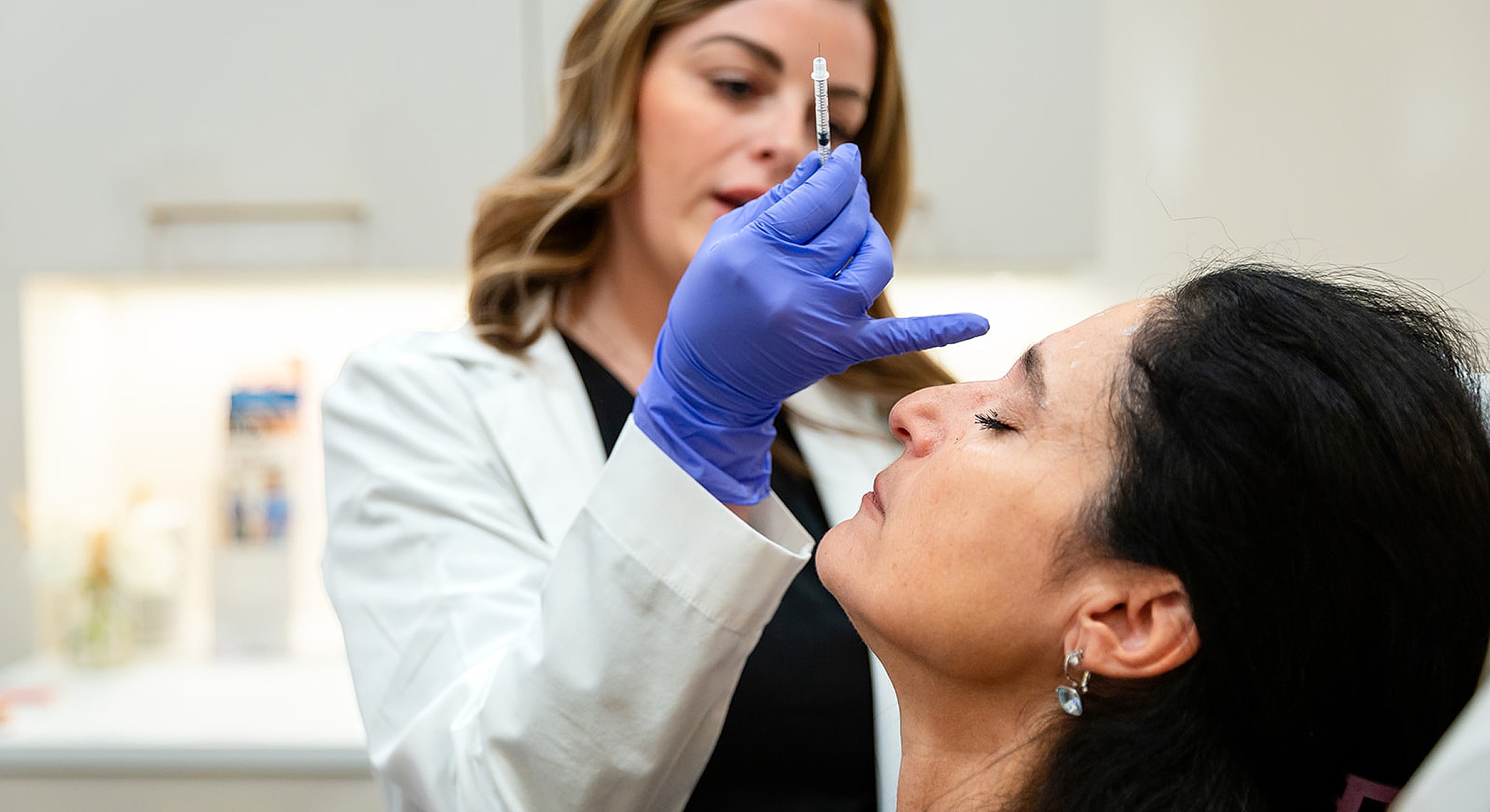 Medical professional performing a cosmetic procedure.