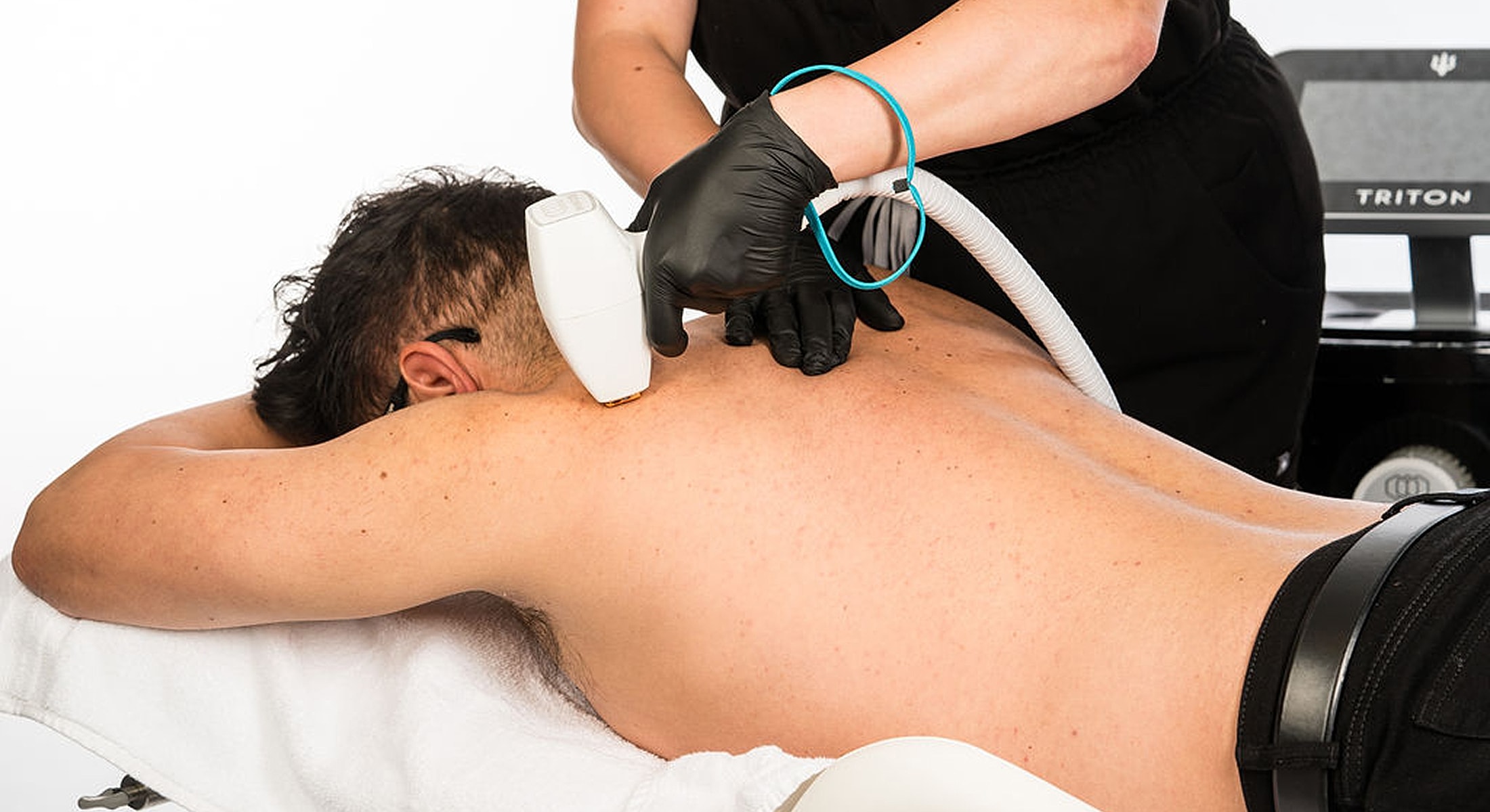 Man receiving skin treatment on back.