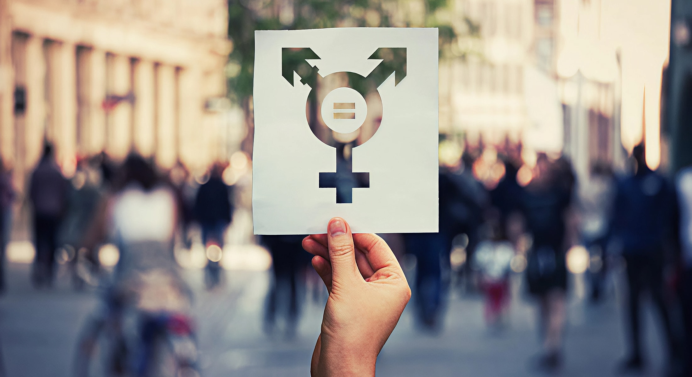 Transgender symbol held above a crowd.